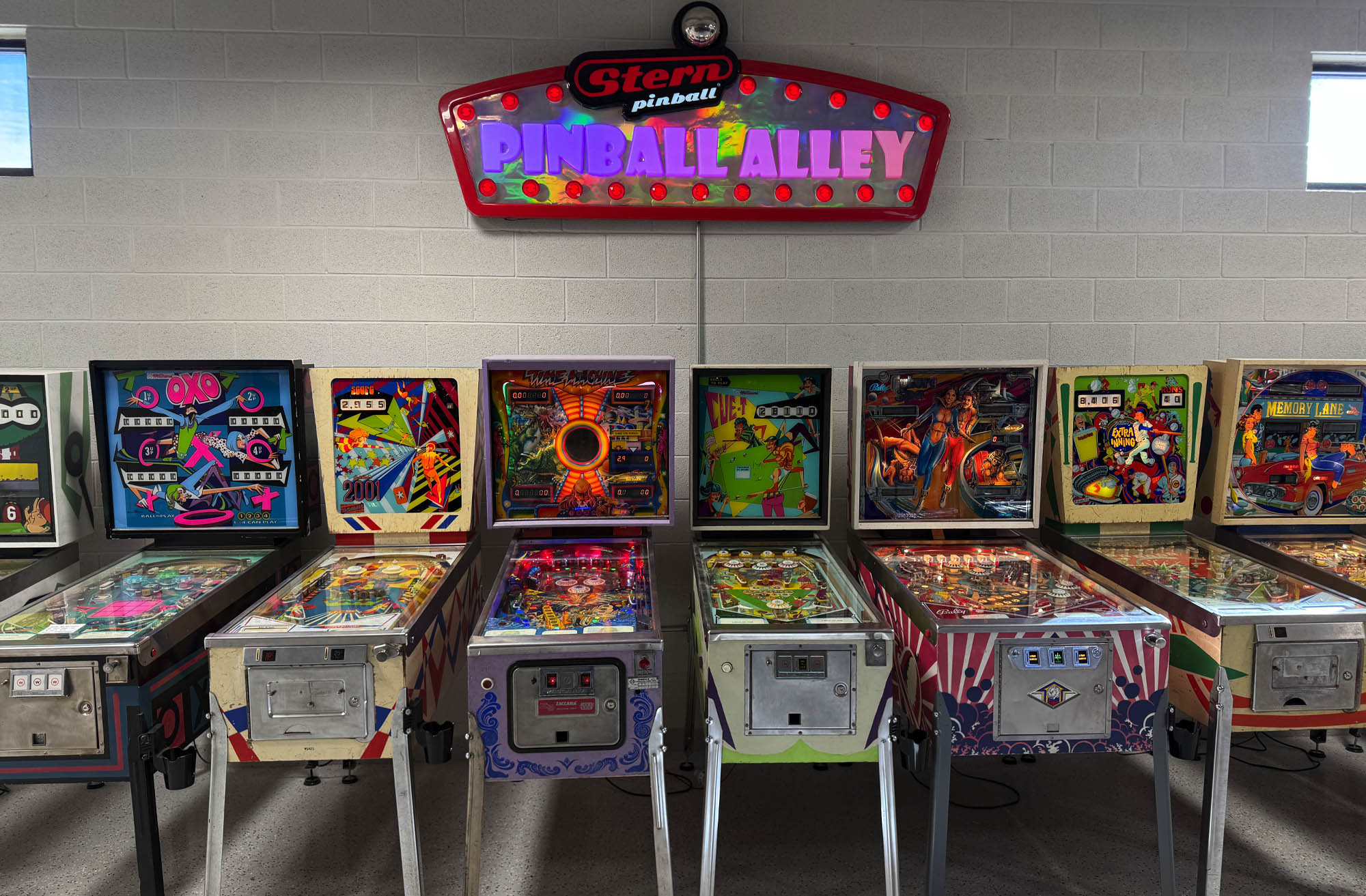 The row of games under the Pinball Alley sign at Pinball Capital